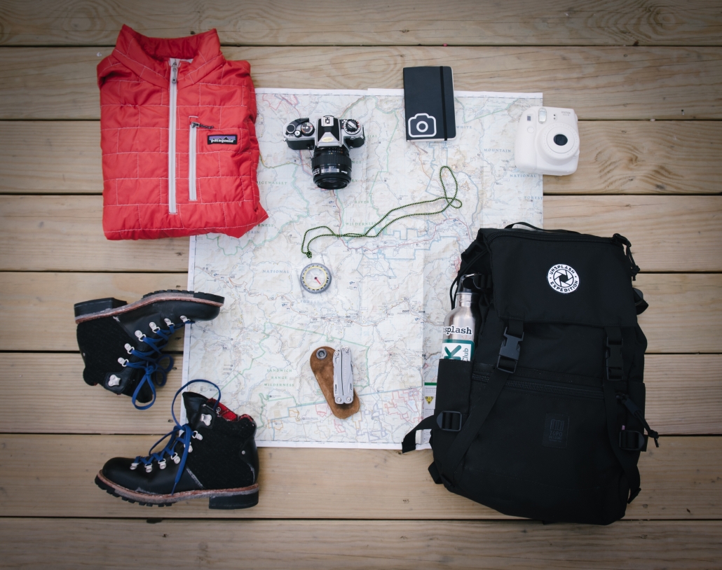 A map with various hiking gear on top of it