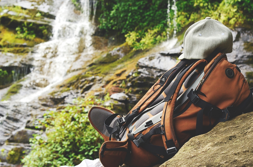 Shallow focus photography of backpack on top of boulder